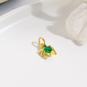 Spider pendant in gold finish with a green heart-shaped gemstone for DIY jewelry making
