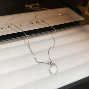 Close-up of elegant opal pendant necklace with box chain in a white jewelry gift box