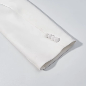 Close-up of elegant white long sleeve cuffs featuring four fabric-covered buttons