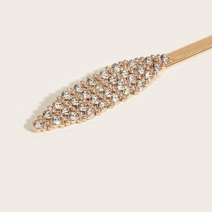 Detail of gold elastic belt with sparkling rhinestone leaf design for dresses