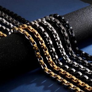 Detailed view of hip hop chain necklaces in gold, silver and black finishes on display