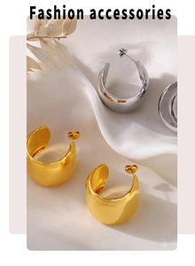 Macro view of gold and silver C-shaped high-polish stainless steel hoop earrings