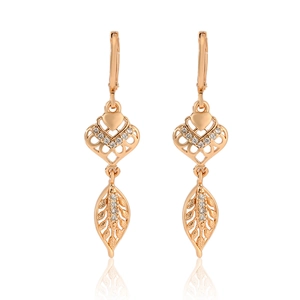 Detail of champagne gold leverback earrings featuring hollow heart and leaf zircon charms