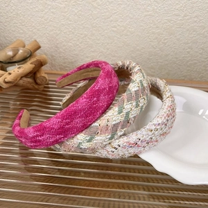 Three textured tweed headbands in pink and light gold with thick padded design