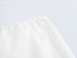Detail of elastic waistband on white cotton vacation set featuring fine fabric texture
