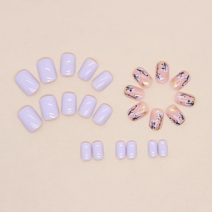 Short lavender and floral press-on nails with gold foil accents in a square-oval shape
