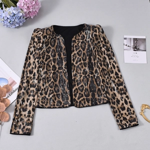 Flat lay of women's leopard print sequin blazer with shoulder pads and fashionable props