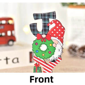 Macro detail of wooden Christmas letter J ornament with festive gnome and gnome patterns