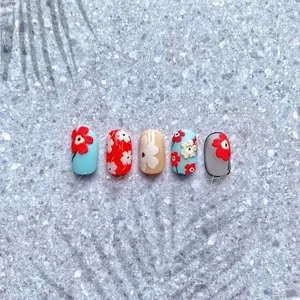 Detail showing colorful floral relief press-on nails with pastoral 3D flower designs