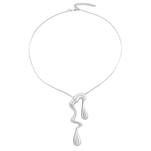 Macro shot of silver liquid metal pendant on a thin chain over white background