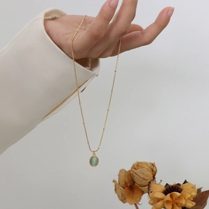 Vintage 18k gold plated titanium steel necklace featuring a green opal oval pendant