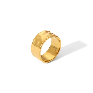 Detailed view of wide gold stainless steel ring with a hammered textured finish