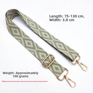 Detail of green and beige embroidered diamond pattern shoulder strap with gold metal hooks