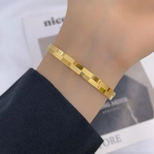 Minimalist checkerboard pattern titanium steel bangle for women in premium gold finish