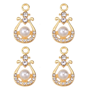 Detailed view of pear-shaped gold pendants with pearls and zircon for DIY jewelry making