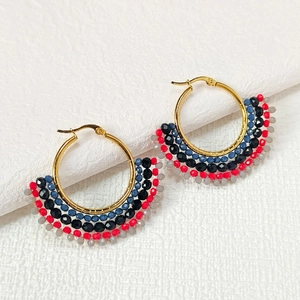 Detailed close-up of fan-shaped beaded hoop earrings with five layers of colorful beads