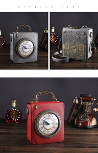 Detail of the vintage clock-shaped crossbody bag featuring golden European building embroidery