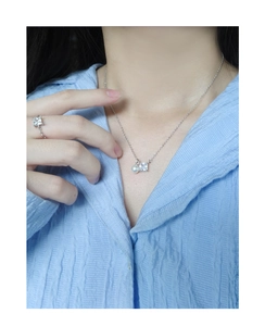 Detail of square zircon and pearl pendant on a delicate silver necklace for women