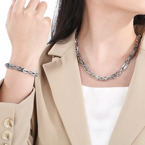 Polished silver Byzantine chain set with necklace and bracelet on a male model