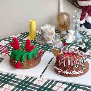 Close-up of festive Christmas cake toppers with reindeer antlers and Merry Christmas banner