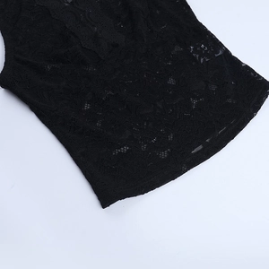 Detailed view of black lace fabric texture and intricate embroidery patterns on a tank top