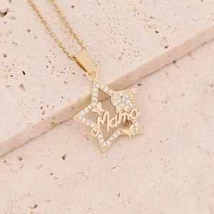 Detail of gold star pendant with 'Mama' lettering and crystal butterfly accents