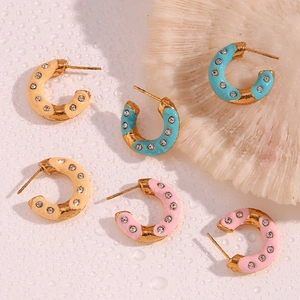 Detail of C-shaped 18K gold plated earrings with colorful enamel and inlaid crystals