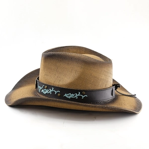 Detail of western straw cowboy hat with bull embroidery, metal studs, and leather band