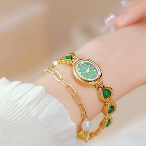 Close-up of gold ladies watch with green jade dial and matching pearl bracelet