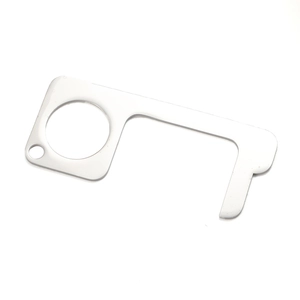 Macro shot of silver non-contact door opener tool with hook and finger hole on white background
