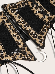 Detail of leopard print corset belt with mesh, silver studs, and crescent zipper pull