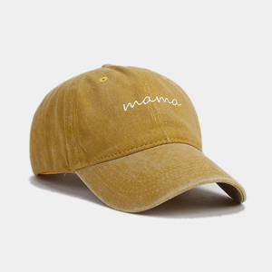 Detailed close-up of mama embroidery on vintage washed cotton mustard yellow baseball cap