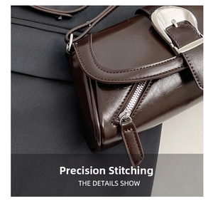 Detailed close-up of dark brown leather handbag featuring silver buckle and precise stitching