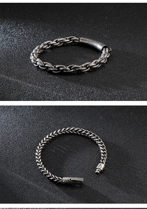Detail of vintage industrial men's wheat and snake chain bracelets in antique silver