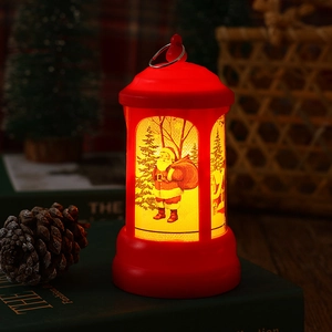 Detailed view of a glowing red vintage Christmas LED lantern with Santa Claus illustration