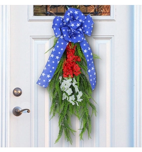 Detail of USA Independence Day door swag with patriotic bow and vibrant faux floral accents