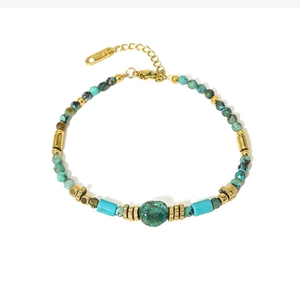 Detailed macro view of bohemian turquoise beaded bracelet with gold stainless steel clasp
