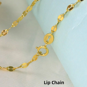 Macro view of gold-plated S925 sterling silver lips chain necklace showing metal texture