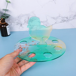 Macro detail of epoxy resin chick storage mold with green gradient and gold flakes
