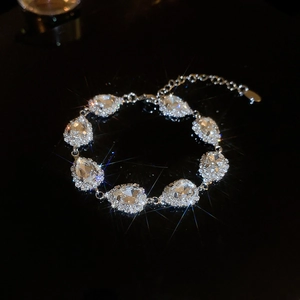 Detail of silver waterdrop jewelry set with sparkling crystals and lobster clasp closure