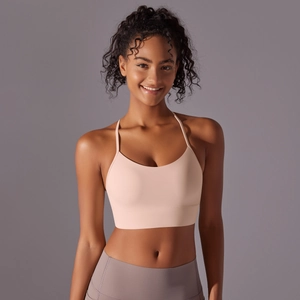 Detail of skin-pink yoga bra showing thin straps and high-elastic seamless fabric texture