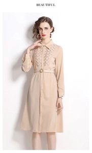 Detailed view of apricot shirt dress featuring woven texture and matching belt buckle