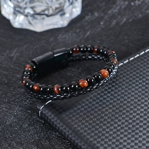 Detail of tiger eye and obsidian beaded bracelet with braided leather and magnetic clasp