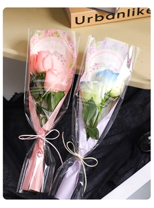 Detail of single rose packaging bags in pink and blue with elegant ribbon bows