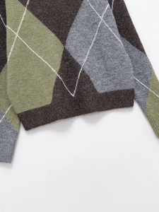 Close-up of Argyle pattern knit sweater with brown and green diamonds and plush texture