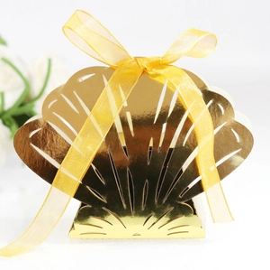 Macro detail of laser-cut hollow pattern and gold silk ribbon on shell candy box