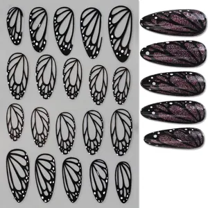 Detail of black butterfly wing nail stickers with white spots and application effect