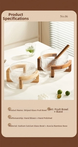 Vertical striped glass salad bowl with cross wooden base and natural sunlight shadows