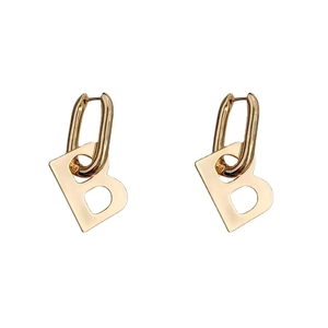 Golden B-shaped dangle earrings with polished oval metal hoops in a minimalist hip hop style