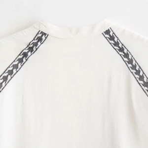 White embroidered blouse for women featuring black contrast patterns on cotton-linen fabric